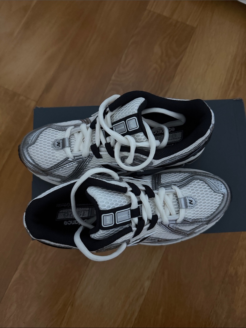 New Balance black and white sneakers with silver details